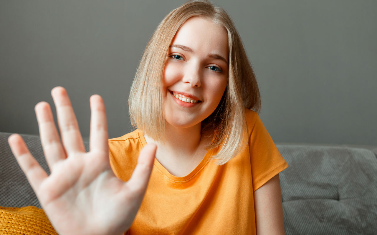 Portræt af ung pige med sin hånd løftet